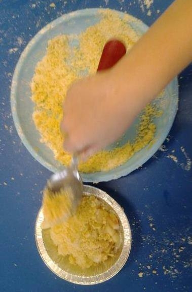 child weighing out mixture for baking